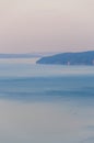 Sailing yacht moves towards Cres Island at sunset on Adriatic Sea. Royalty Free Stock Photo