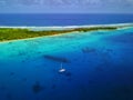 Aerial View Of A Sunken WWII Ship Wreck With An Anchored Yacht And Beautiful Island/sea Back Scene