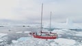 Sailing yacht sail in antarctic iceberg ocean