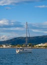 Sailing yacht, sailboat in the bay on city landscape background