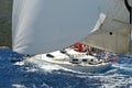 A sailing yacht sailing with spinnaker in a wavy sea Royalty Free Stock Photo