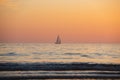 Sailing yacht on sunrise over the sea and beautiful cloudscape. Colorful ocean beach sunset. Royalty Free Stock Photo