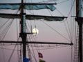 Sailing yacht tall ship illuminated by the light of a full moon