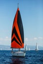 Sailing yacht under colorful bright gennaker participates in the regatta along the Greek coast. Royalty Free Stock Photo