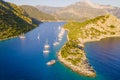 Sailing yachts at anchor off calm lagoon of Aegean sea Royalty Free Stock Photo