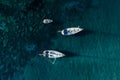 Sailing yachts anchored in blue sea, top view. Sailing yacht on dark background, aerial view