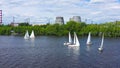 Sailing yachts on background of factories. Video. Top view of beautiful group of sailing yachts floating near coast with