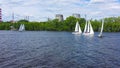 Sailing yachts on background of factories. Video. Top view of beautiful group of sailing yachts floating near coast with