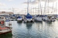 Sailing yachts and fishing boats in the marina in the evening. Romantic rest and business Royalty Free Stock Photo