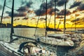 Sailing yachts moored at the pier at sunset