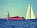 Sailingboat and Staten island ferry boating near Statue of Liberty