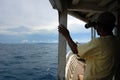 Sailor with binoculars on wooden boat