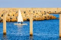 Sailor boat on blue ocean water by the shore