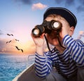 Sailor boy with binoculars in the boat Royalty Free Stock Photo