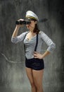 Sailor captain looking for right route in gray background Royalty Free Stock Photo