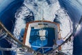 Sailor gets ready reels and rods for marlin game fishing at sea near Saint-Denis, Reunion island. Royalty Free Stock Photo