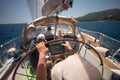 Sailor holding the helm of the sailboat Royalty Free Stock Photo