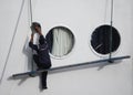 Sailor man cleaning windows on cruise ship on Nile river. Egypt Royalty Free Stock Photo