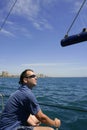 Sailor sailing blue tropical sea on sailboat