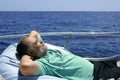 Sailor senior man having a rest on summer boat