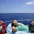 Sailor senior man having a rest on summer boat