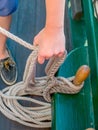 A sailor ties ropes securely on a ship