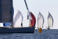 A sailor trying to open a genoa in a silhuette