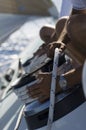 Sailor tying rope onto windlass close-up of hands Royalty Free Stock Photo