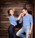 Sailors couple love story. Man kissing woman hand. Wooden background