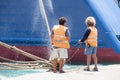 Sailors in the harbor anchoring ship