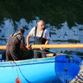 Sailors holding wooden spar