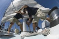 Sailors Operating Windlass On Yacht