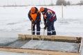 Sailors work at the lane with a fenced wooden formwork Royalty Free Stock Photo