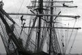 Sailors working aloft in the rigging of a traditional tallship