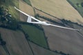 Sailplane soaring over farmland. Royalty Free Stock Photo