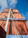 Sails and rigging hanging from the mast of an old sailing boat Royalty Free Stock Photo