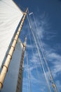 Sails and Wooden Masts of Old Schooner Sailboat Reaching to Blue