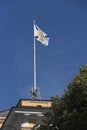 Saint Andrew Andreevsky flag Ensign of the Russian Navy on a flagpole waving the roof of the Admiralty building on a blue sky