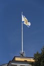 Saint Andrew Andreevsky flag Ensign of the Russian Navy on a flagpole waving the roof of the Admiralty building on a blue sky