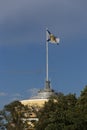 Saint Andrew Andreevsky flag Ensign of the Russian Navy on a flagpole waving the roof of the Admiralty building on a blue sky