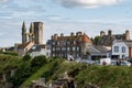 Cityscape of Saint Andrews city with St Rules Tower, ruins, and tourists