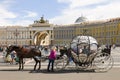 SAINT Beautiful carriage with a horse standing on Palace square among the many tourists in