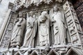Saint-Denis holds his head. Statue of portal of Notre Dame de Paris Royalty Free Stock Photo