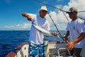 People fix tuna fish as a bait for marlin fishing, at sea near Saint-Denis, Reunion island.