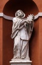 Saint Francis statue on the portal of St. Barnabas Church in Modena, Italy