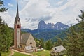 Saint Giacomo church near Santa Cristina and Ortisei with Sassolungo and Sassopiatto mountains in the background, Val Gardena