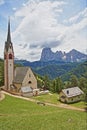 Saint Giacomo church near Santa Cristina and Ortisei with Sassolungo and Sassopiatto mountains in the background, Val Gardena Royalty Free Stock Photo