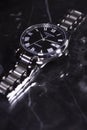 Saint-Imier, Switzerland 31.03.2020 - Closeup image of Longines watch lying on a marble table stainless steel case black