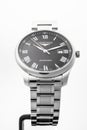 Saint-Imier, Switzerland, 2.02.2020 - Longines automatic silver steel body with bracelet watch close-up, black clock
