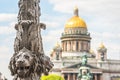 Saint Isaac`s Cathedral out of focus, in the foreground the sculpture of lions on a pillar. Saint-Petersburg, Russia.